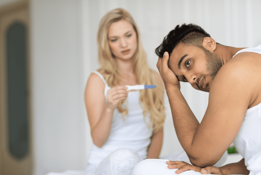 woman checking pregnancy and a man thinking about male fertility test